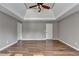 A spacious main bedroom featuring hardwood floors, neutral paint, base trim, and two access doors at 4770 Spring Park Cir, Suwanee, GA 30024
