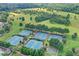 Aerial view of multiple tennis courts surrounded by trees and landscaping at 4770 Spring Park Cir, Suwanee, GA 30024