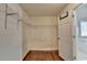 A walk-in closet with wire shelving, base molding, natural light, and hardwood floor at 4770 Spring Park Cir, Suwanee, GA 30024