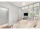 Bright bedroom featuring a modern sliding-glass-partition wall, and hardwood flooring at 1055 Piedmont Ne Ave # 106, Atlanta, GA 30309