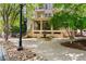 Beautiful building exterior with stone accents, a water feature, and lush landscaping at 1055 Piedmont Ne Ave # 106, Atlanta, GA 30309