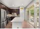A view of the kitchen featuring an island, stainless steel appliances, and a sliding glass door at 1055 Piedmont Ne Ave # 106, Atlanta, GA 30309