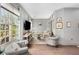 Bright living room featuring hardwood floors, large windows, and elegant furnishings at 1055 Piedmont Ne Ave # 106, Atlanta, GA 30309
