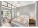 View of Main bedroom featuring a chandelier, hardwood floors, light gray walls, and view into the living room at 1055 Piedmont Ne Ave # 106, Atlanta, GA 30309