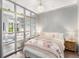 View of Main bedroom featuring a chandelier, hardwood floors, light gray walls, and view into the living room at 1055 Piedmont Ne Ave # 106, Atlanta, GA 30309