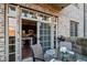 Cozy brick patio with glass table, chairs, and sliding doors to the kitchen at 1055 Piedmont Ne Ave # 106, Atlanta, GA 30309