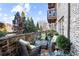 Outdoor patio with stone retaining wall, colorful outdoor rug, wicker furniture, and views of trees at 1055 Piedmont Ne Ave # 106, Atlanta, GA 30309
