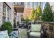 Outdoor patio with stone retaining wall, outdoor furniture, green space, and views of trees and skyline at 1055 Piedmont Ne Ave # 106, Atlanta, GA 30309