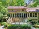 Back exterior features a deck and screened porch with a beautiful backyard view at 4853 Carlene Sw Way, Lilburn, GA 30047