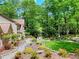 Serene backyard with stone pathway, wooden bridge, and meticulously landscaped garden at 4853 Carlene Sw Way, Lilburn, GA 30047