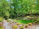 Lush backyard featuring a stone path, bridges, and manicured garden at 4853 Carlene Sw Way, Lilburn, GA 30047