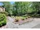 Well-manicured backyard featuring a stone pathway and lovely landscaping at 4853 Carlene Sw Way, Lilburn, GA 30047