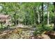 Beautiful backyard with lush landscaping and a charming bridge creating a serene outdoor oasis at 4853 Carlene Sw Way, Lilburn, GA 30047