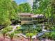 Beautiful backyard with lush landscaping, deck, screened porch, and manicured garden at 4853 Carlene Sw Way, Lilburn, GA 30047