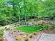 Lush backyard featuring a stone pathway and bridge leading to a private retreat at 4853 Carlene Sw Way, Lilburn, GA 30047