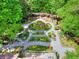 Unique backyard featuring elegant garden paths, lush landscaping, and a deck off the back of the house at 4853 Carlene Sw Way, Lilburn, GA 30047