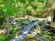 Lush backyard garden featuring decorative gravel paths and mature trees at 4853 Carlene Sw Way, Lilburn, GA 30047
