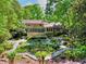 Beautiful backyard with lush landscaping, deck, screened porch, and manicured garden at 4853 Carlene Sw Way, Lilburn, GA 30047