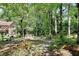 Lush backyard with a charming footbridge leading to the house; beautiful landscape at 4853 Carlene Sw Way, Lilburn, GA 30047