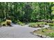 Backyard with detailed gravel garden paths lined with rocks and vegetation at 4853 Carlene Sw Way, Lilburn, GA 30047
