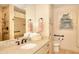 Bathroom featuring granite counters, modern sink fixtures, and decorative mirror at 4853 Carlene Sw Way, Lilburn, GA 30047