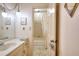 Bathroom vanity with marble countertop with adjoining bathroom with shower-tub combination, creating an accessible space at 4853 Carlene Sw Way, Lilburn, GA 30047