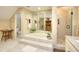 Elegant bathroom featuring a soaking tub, glass-enclosed shower, and neutral tile work at 4853 Carlene Sw Way, Lilburn, GA 30047
