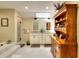 Spacious bathroom with soaking tub, glass shower, double vanity, and furniture-style shelving at 4853 Carlene Sw Way, Lilburn, GA 30047