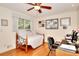 Comfortable bedroom with hardwood floors, bright ceiling fan, and a cozy daybed at 4853 Carlene Sw Way, Lilburn, GA 30047