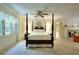 Spacious Primary bedroom with a four-poster bed, ceiling fan, and a fireplace at 4853 Carlene Sw Way, Lilburn, GA 30047