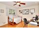Comfortable bedroom with hardwood floors, desk area, and bright, sunny window at 4853 Carlene Sw Way, Lilburn, GA 30047