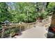 Wooden deck with railing offering a view of the landscaped backyard at 4853 Carlene Sw Way, Lilburn, GA 30047
