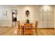 Cozy dining area featuring hardwood floors, a wooden table with chairs, and built-in storage cabinets at 4853 Carlene Sw Way, Lilburn, GA 30047