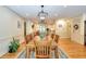 Spacious dining room with hardwood floors, decorative lighting, and adjacent access to kitchen at 4853 Carlene Sw Way, Lilburn, GA 30047