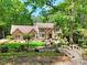 Charming brick home featuring lush front yard and inviting bridge at 4853 Carlene Sw Way, Lilburn, GA 30047