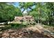 Beautiful home with a bridge and landscaping, surrounded by lush trees on a sunny day at 4853 Carlene Sw Way, Lilburn, GA 30047