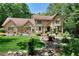 Charming brick home with well-manicured lawn and landscaping, nestled among mature trees at 4853 Carlene Sw Way, Lilburn, GA 30047