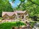 Charming brick home with lush landscaping, mature trees, and inviting front yard at 4853 Carlene Sw Way, Lilburn, GA 30047