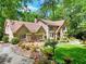 Beautiful brick home featuring a well-manicured lawn, stone pathways, and picturesque setting at 4853 Carlene Sw Way, Lilburn, GA 30047