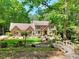 Charming brick home surrounded by mature trees and a beautifully landscaped front yard at 4853 Carlene Sw Way, Lilburn, GA 30047
