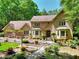 Attractive brick home with beautifully landscaped front yard, walkway bridge, and mature trees at 4853 Carlene Sw Way, Lilburn, GA 30047