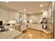 Bright kitchen featuring white cabinets, granite countertops, and stainless steel appliances at 4853 Carlene Sw Way, Lilburn, GA 30047