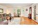 Bright living room with hardwood floors, large windows, and a stylish patterned sofa at 4853 Carlene Sw Way, Lilburn, GA 30047