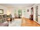 Cozy living room featuring a bay window, hardwood floors, and traditional furnishings at 4853 Carlene Sw Way, Lilburn, GA 30047