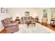 Cozy living room featuring a comfortable sofa, armchair, and a decorative rug at 4853 Carlene Sw Way, Lilburn, GA 30047