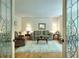 Cozy living room with decorative glass doors, traditional furnishings, and hardwood flooring at 4853 Carlene Sw Way, Lilburn, GA 30047