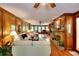 Spacious living room with wood paneling, a fireplace, hardwood floors, and large windows at 4853 Carlene Sw Way, Lilburn, GA 30047