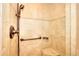 Walk-in shower showcasing tiled walls and a bronze shower head with accessible grab bar at 4853 Carlene Sw Way, Lilburn, GA 30047
