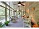 Inviting sunroom with brick accents, lots of windows, and comfortable wicker furniture at 4853 Carlene Sw Way, Lilburn, GA 30047
