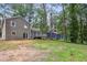 Large backyard with mature trees surrounding the home at 6249 Townsend Way, Riverdale, GA 30296